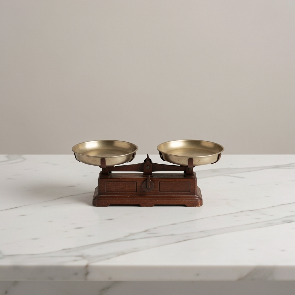 A small two-pan balance scale centered on a clean marble surface, soft diffuse light